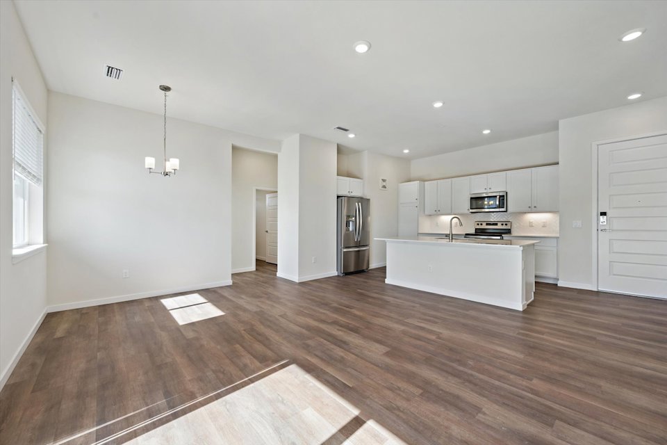 A large kitchen with white cabinets.