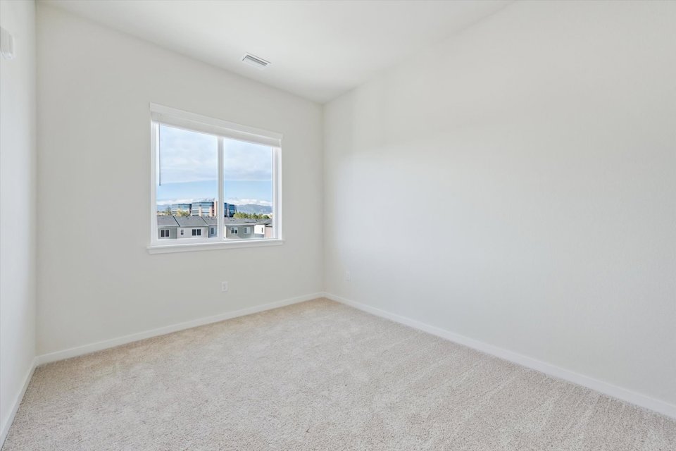 A room with a window and a carpet.