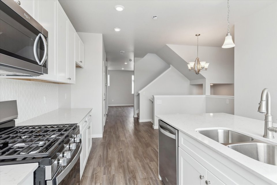 A kitchen with white cabinets.