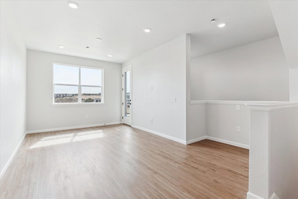 A room with a wood floor and a window.