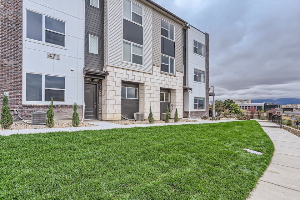 A building with a grass lawn.