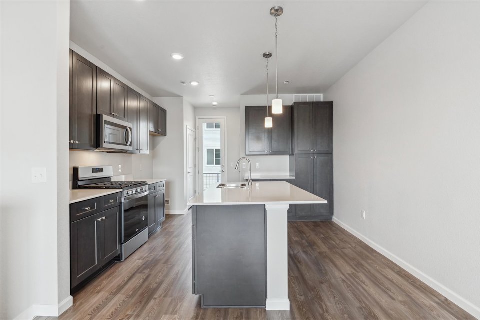 A kitchen with black cabinets.