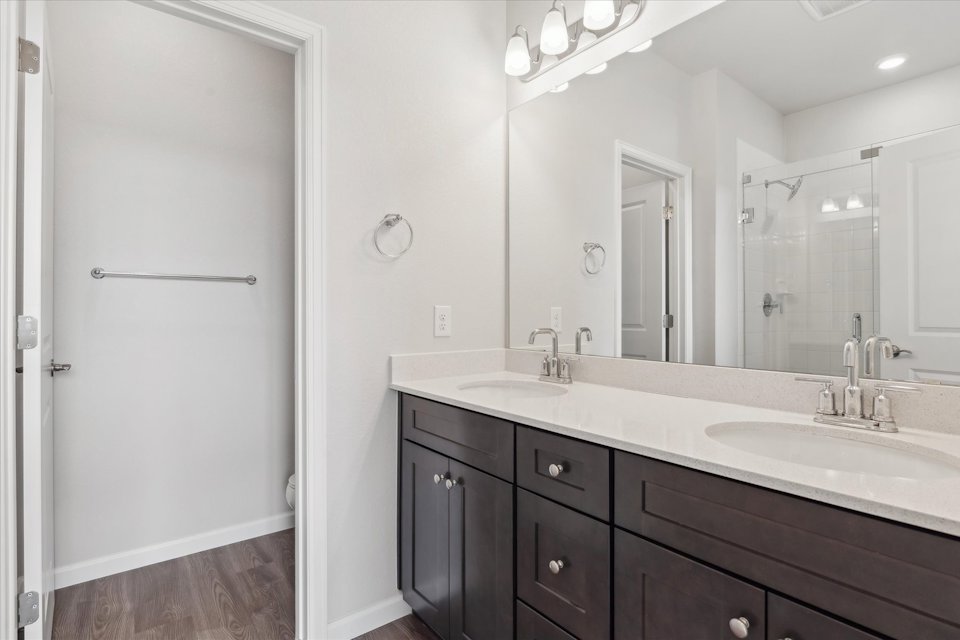 A bathroom with a large mirror.