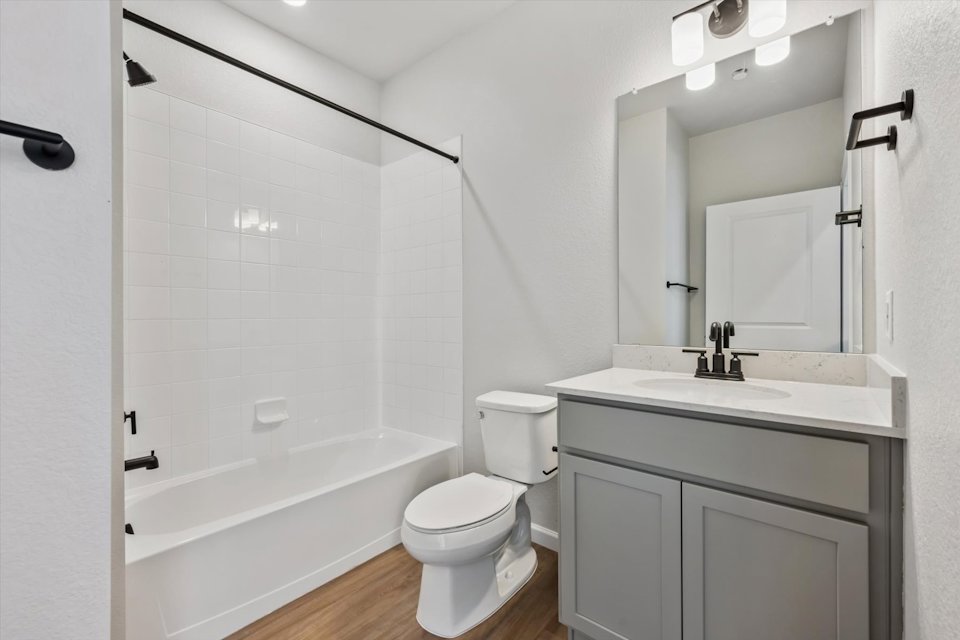 A bathroom with a tub toilet and sink.