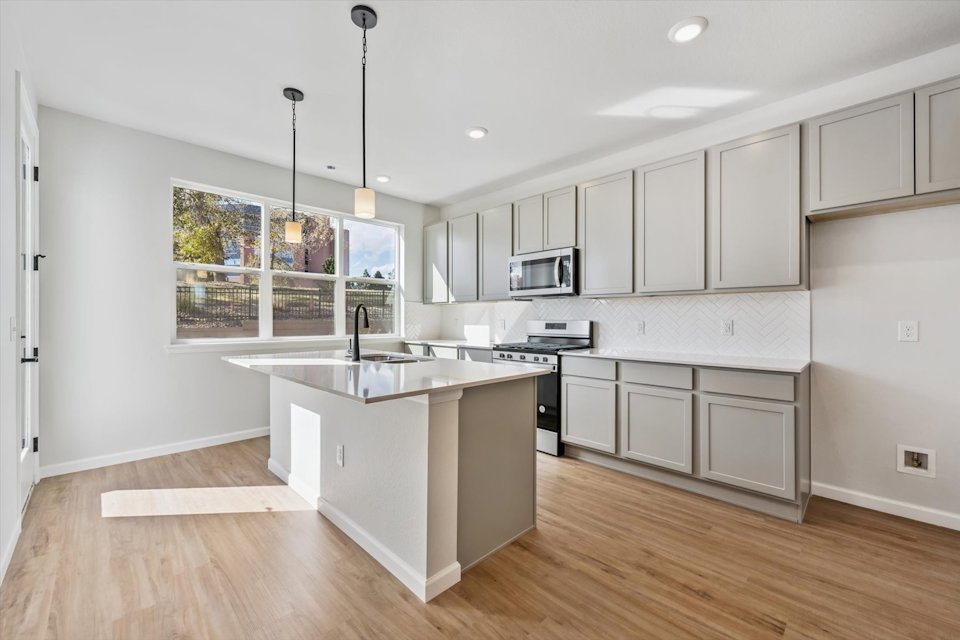 A kitchen with white cabinets.