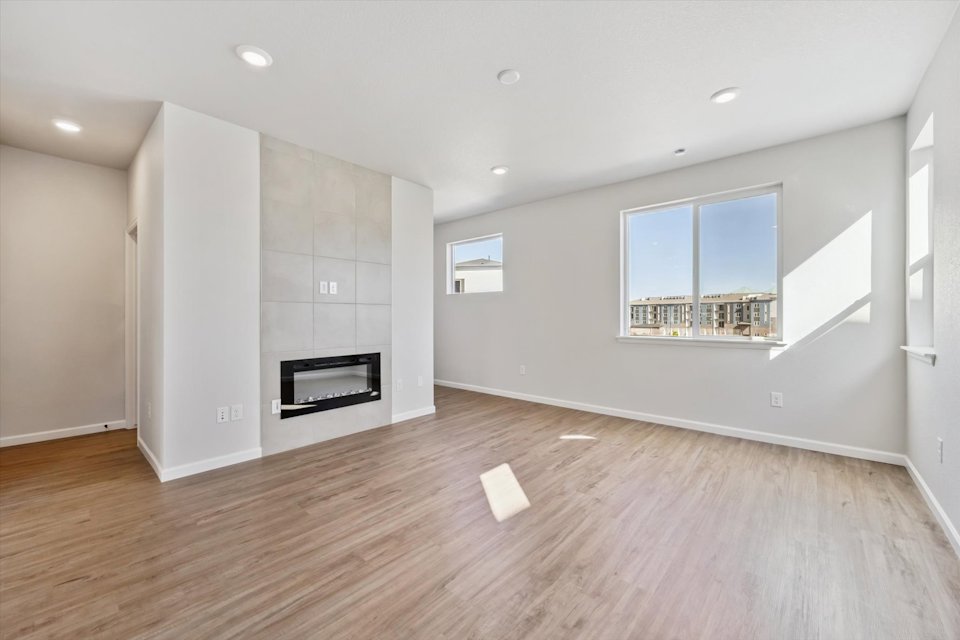A room with white walls and a wood floor.