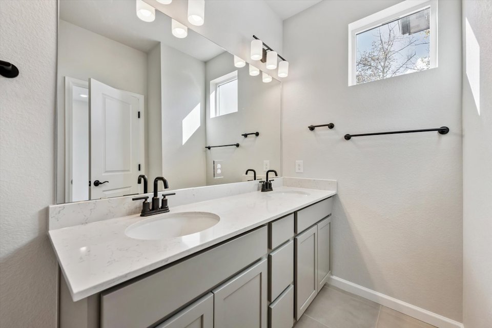 A bathroom with a large mirror.
