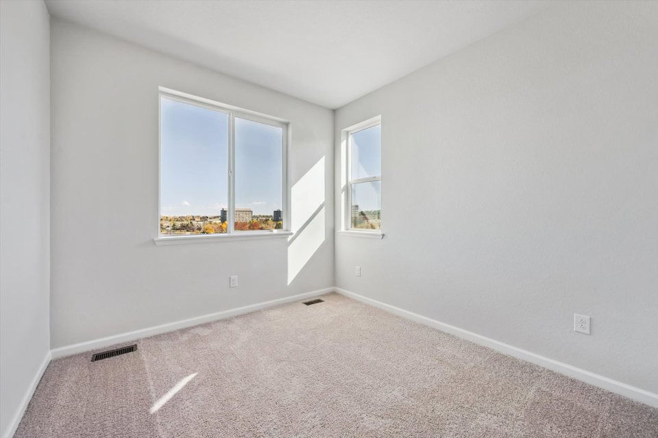 A room with a window and a carpet.