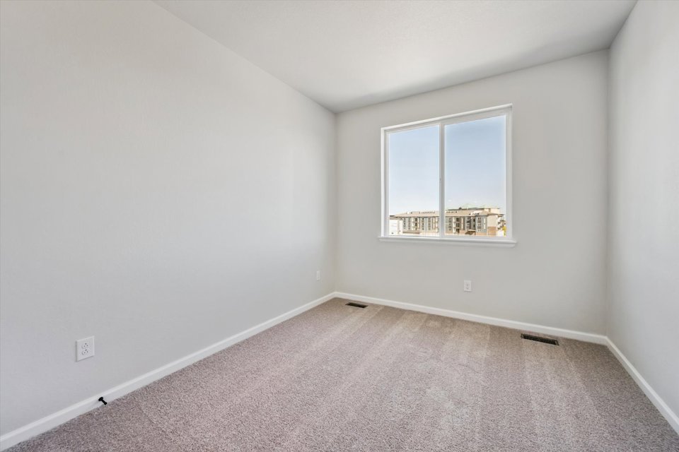 A room with a window and a carpet.