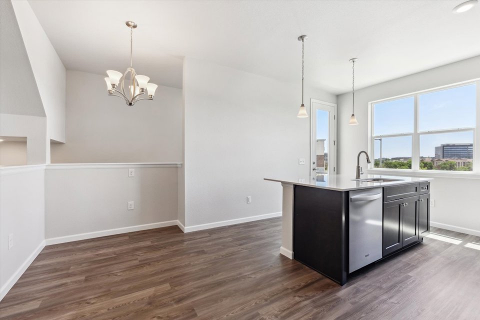 A kitchen with a wood floor.