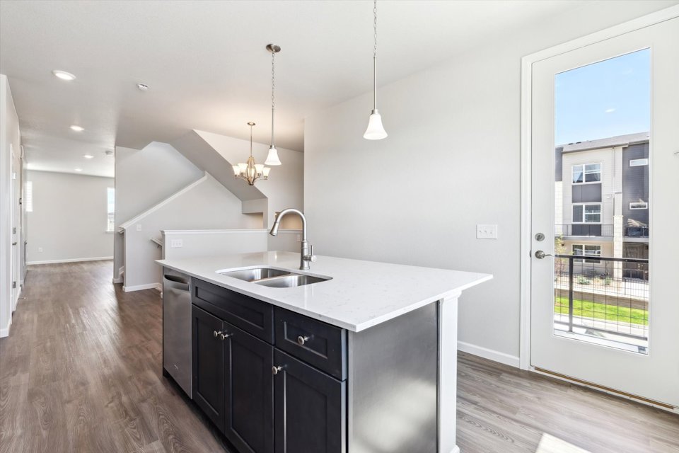 A kitchen with a large window.