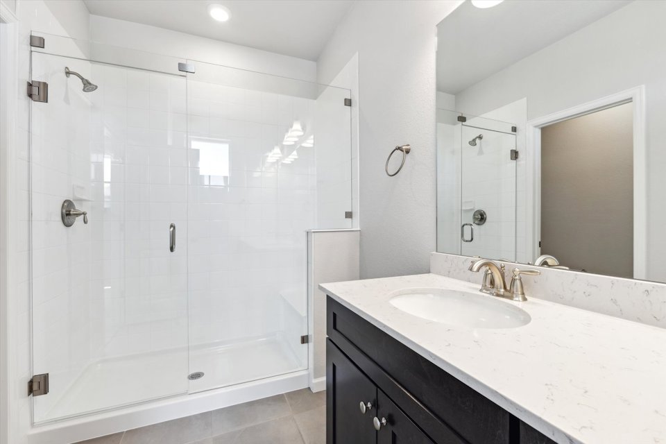 A bathroom with a glass shower.