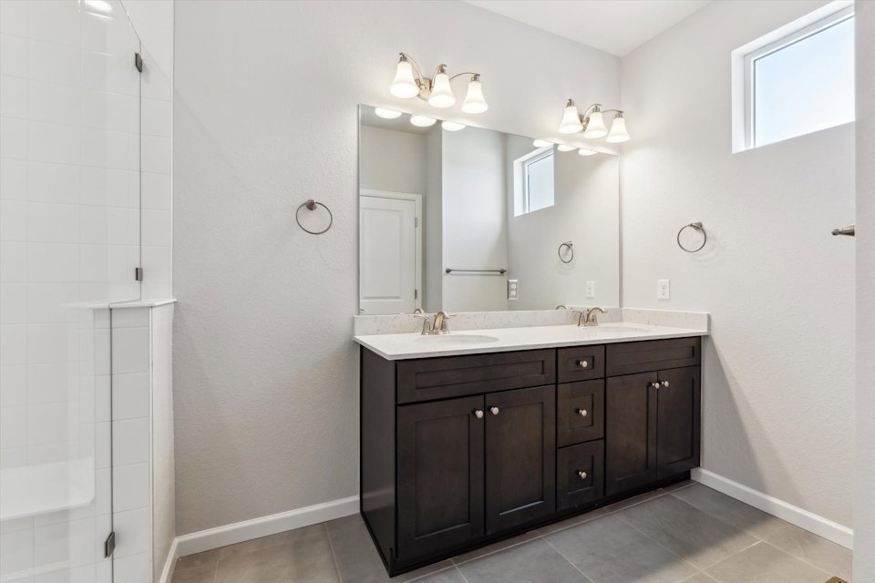 A bathroom with a large mirror.