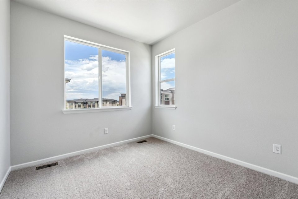 A room with a window and a view of the water.