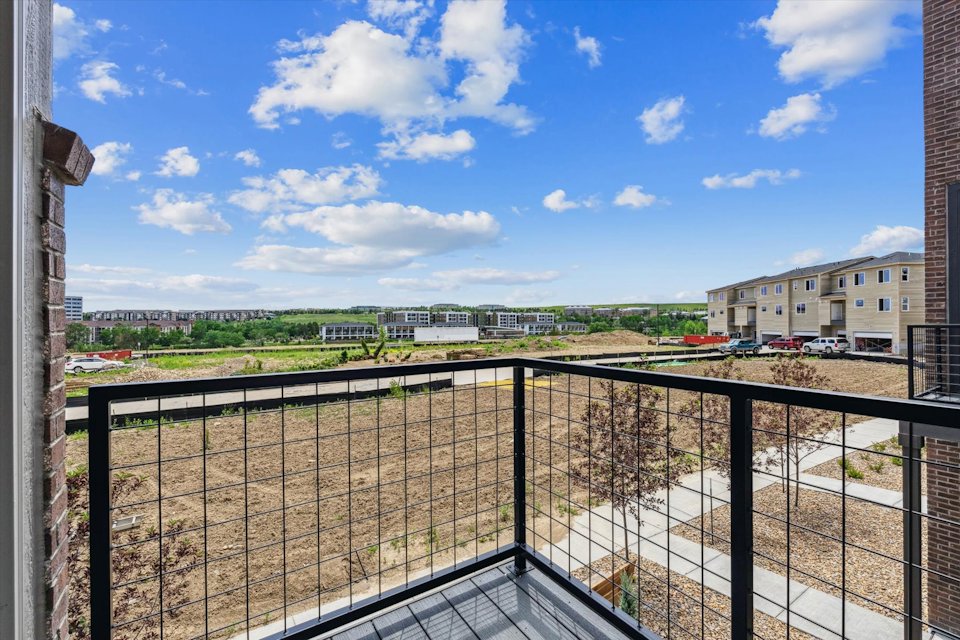 A fenced off area with buildings in the background.
