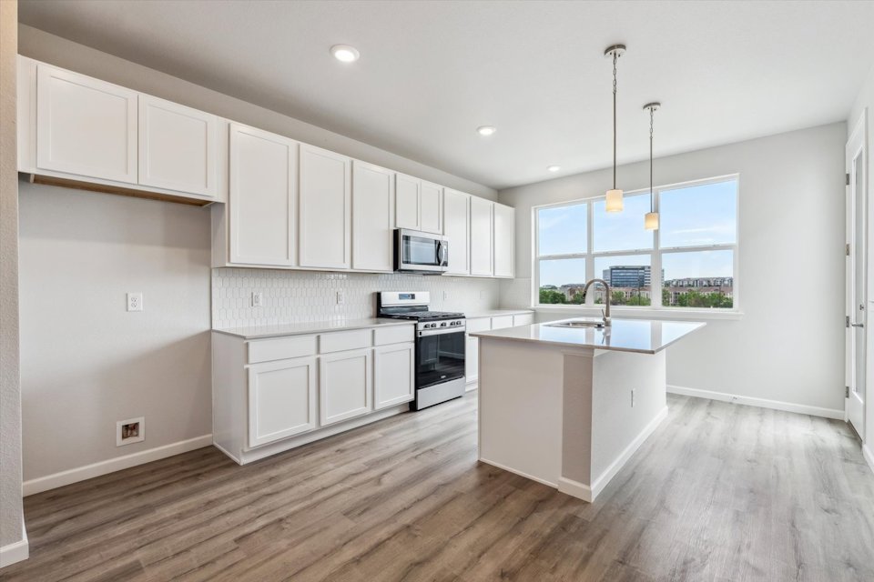 A kitchen with white cabinets.
