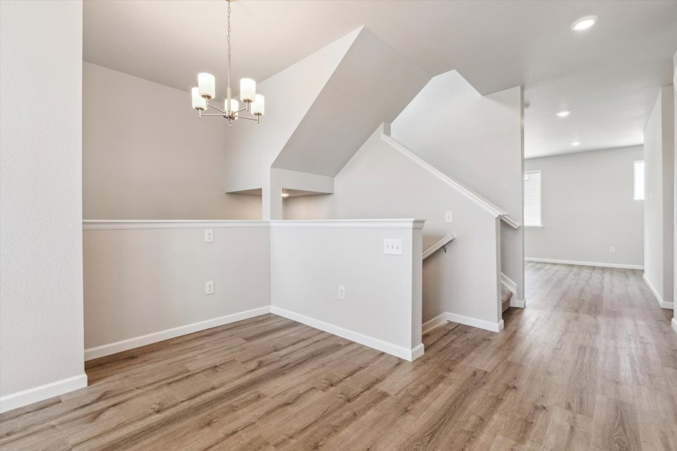 A room with white walls and a wood floor.