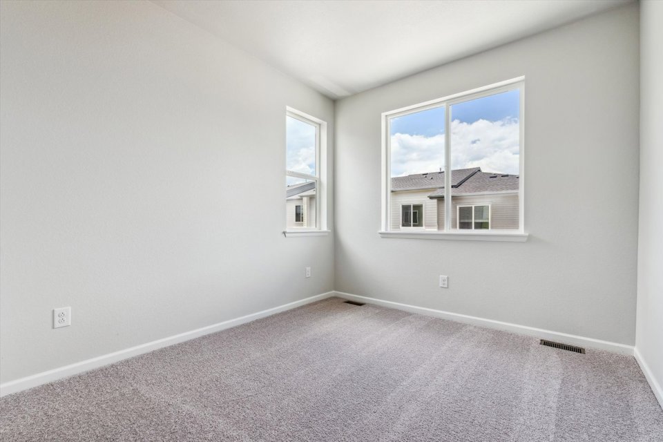 A room with a window and a carpet.