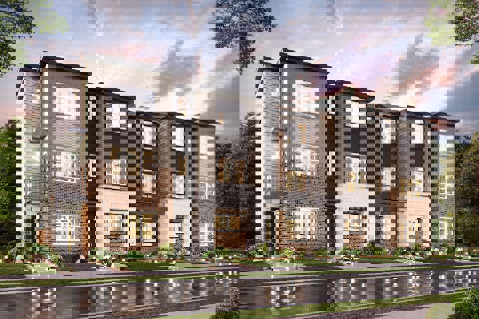 A large brick building with a pond in front of it.