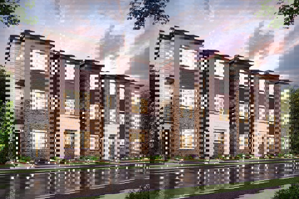 A large brick building with a pond in front of it.