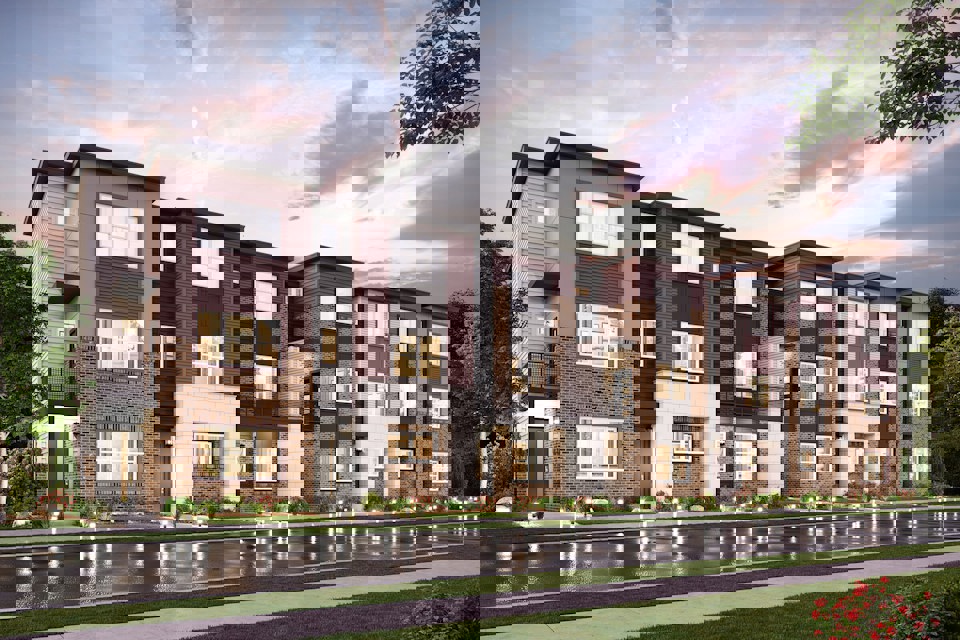 A building with a pool in front.