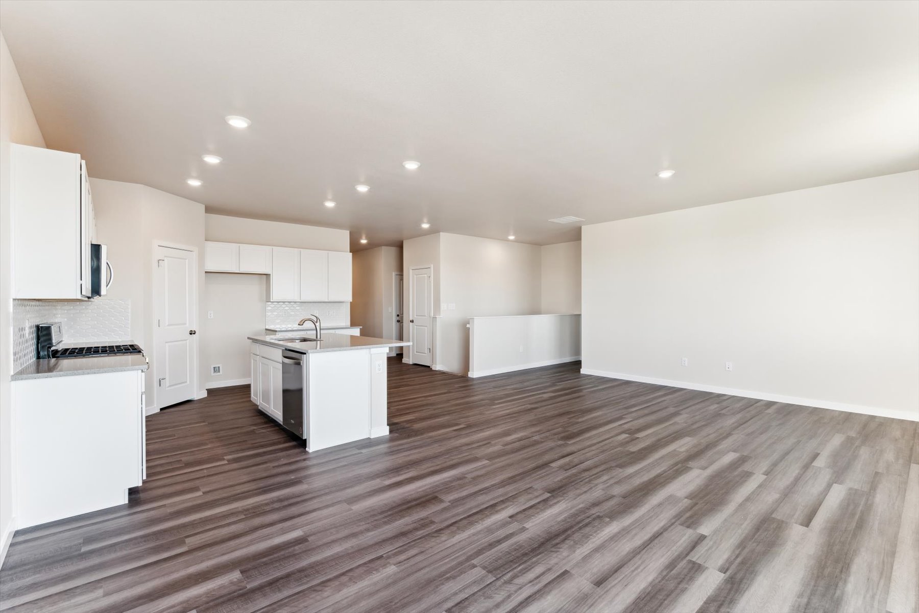 A large kitchen with white cabinets.