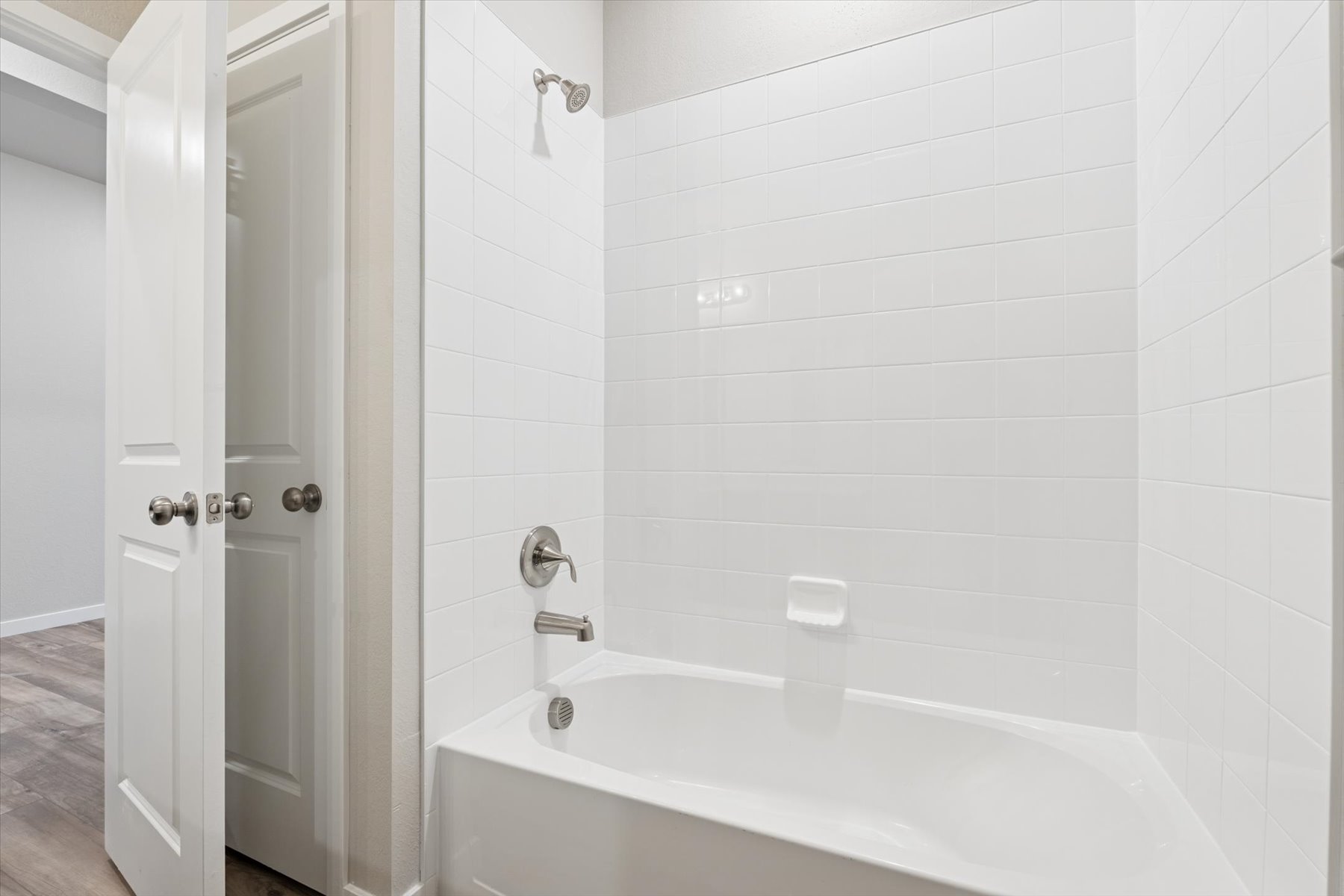 A bathtub in a bathroom.