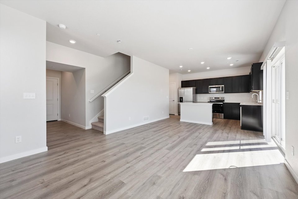 A large kitchen with black cabinets.