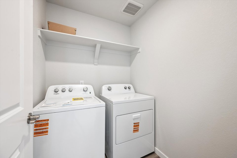 A washing machine in a room.