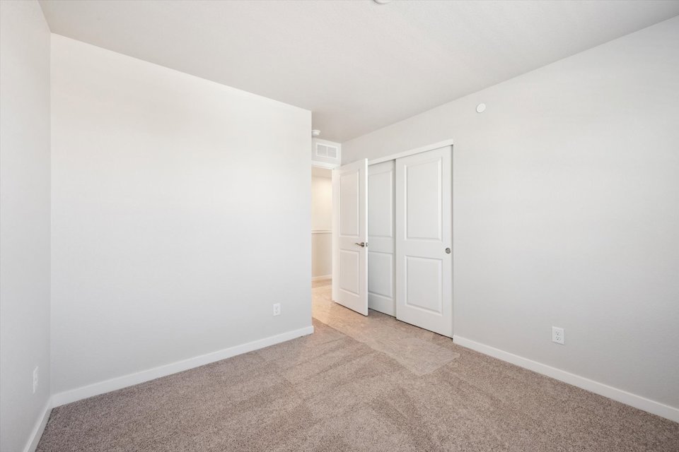 A hallway with white doors.