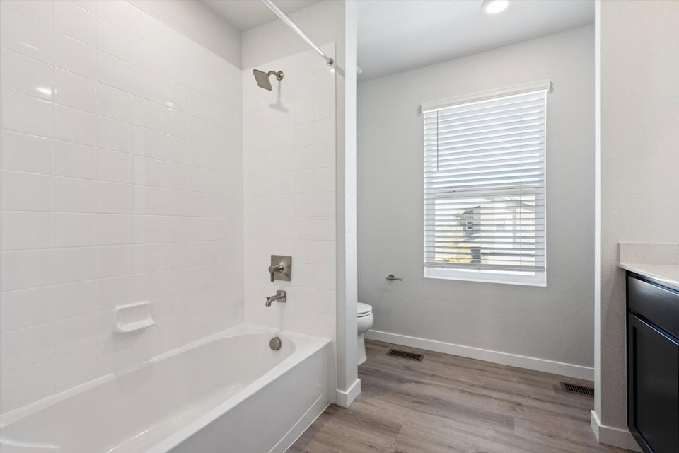 A bathroom with a tub toilet and sink.