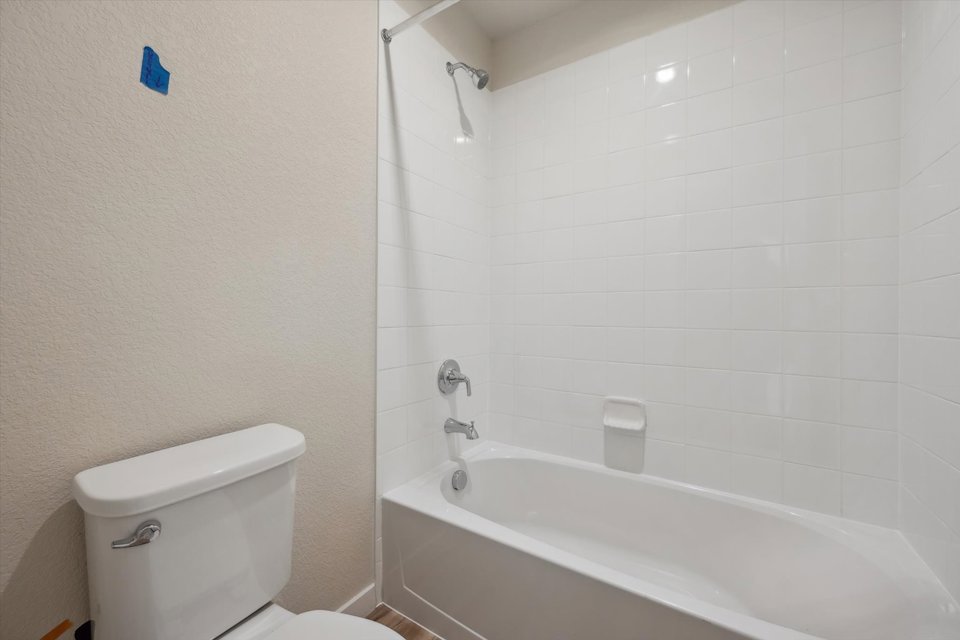 A bathroom with a bathtub toilet and toilet.