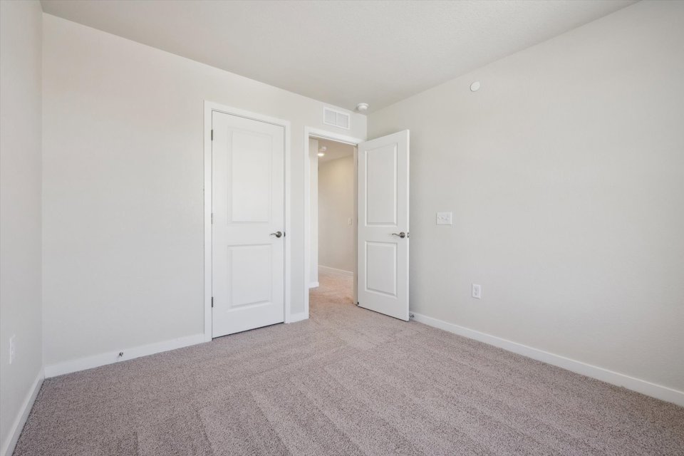 A hallway with white doors.