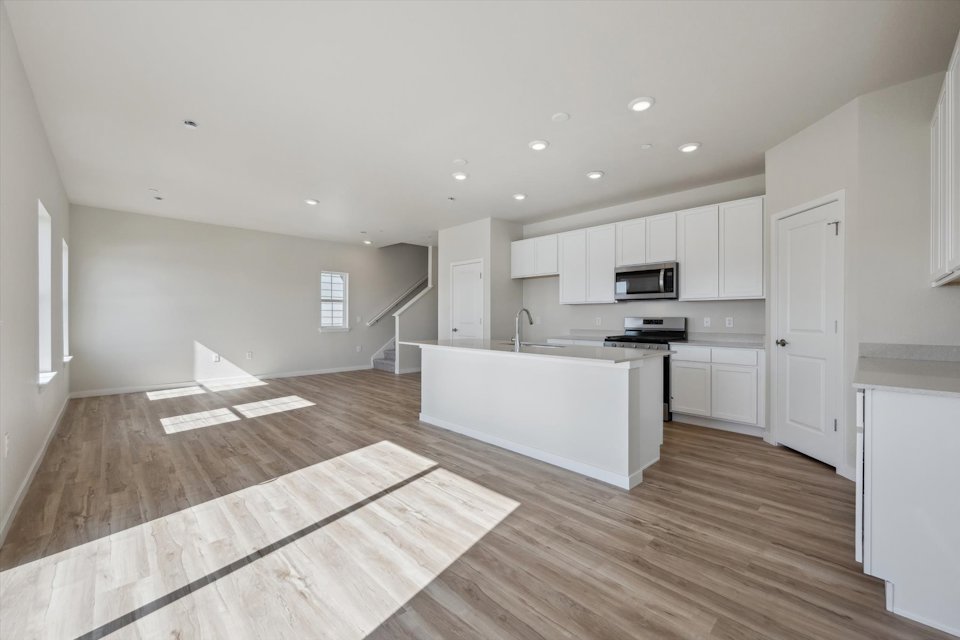 A kitchen with white cabinets.