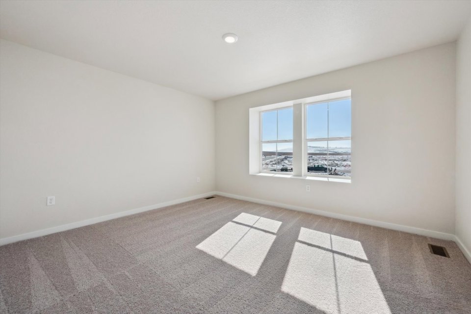 A room with a window and a tile floor.