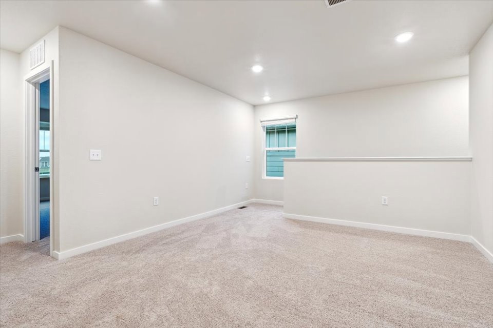 A room with a carpet and a window.