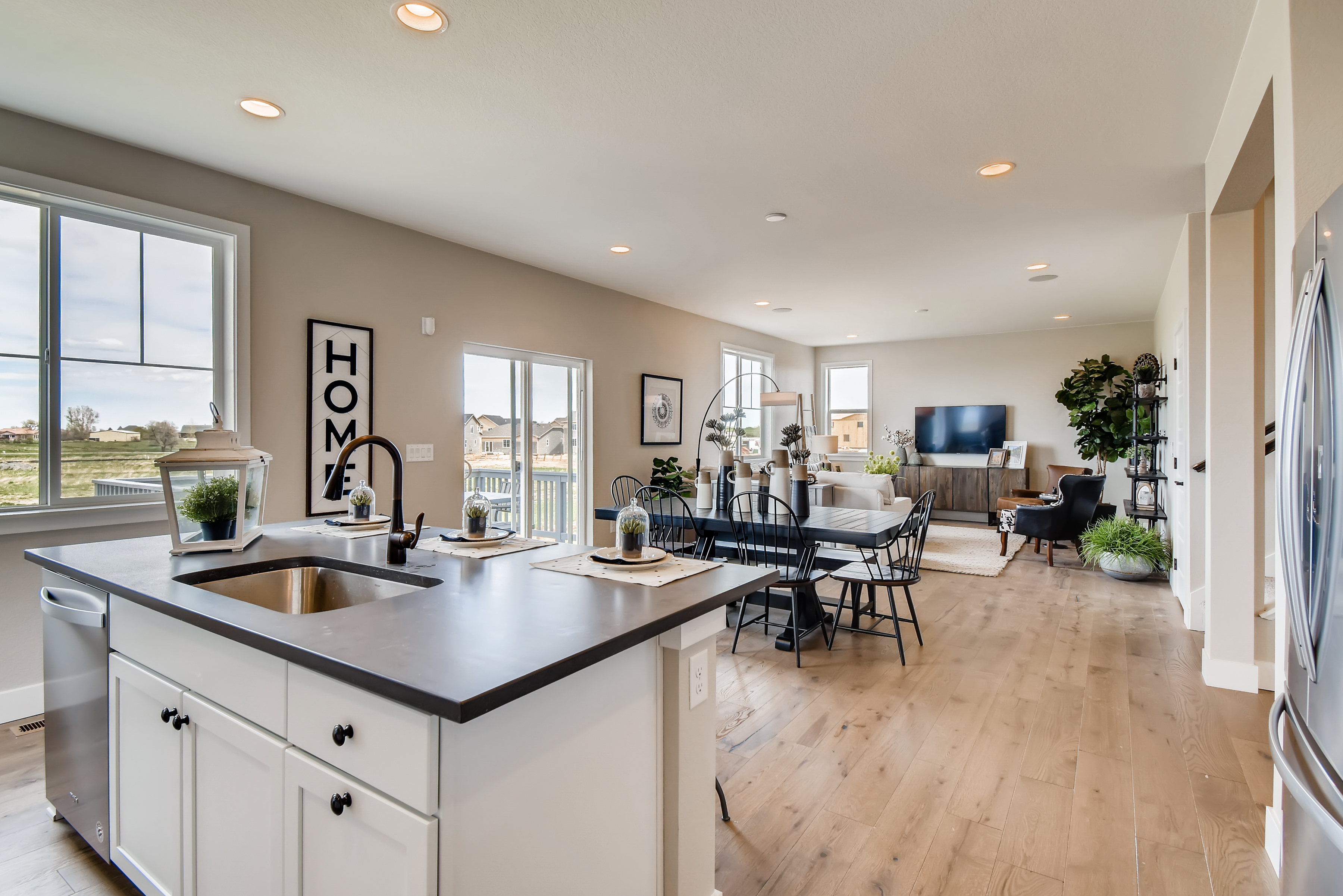 A kitchen with a wood floor.