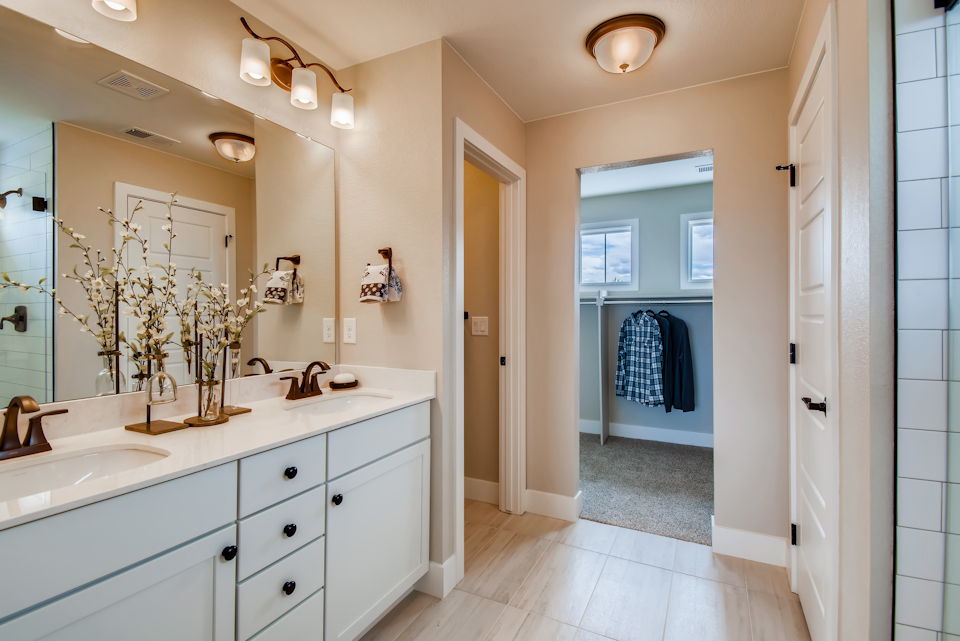 A bathroom with a large mirror.