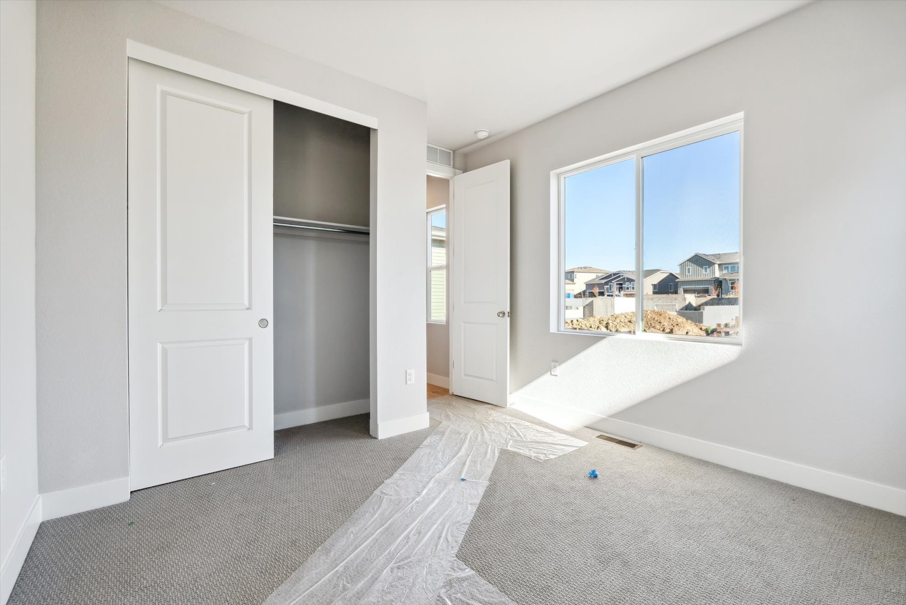 A room with a window and a door.