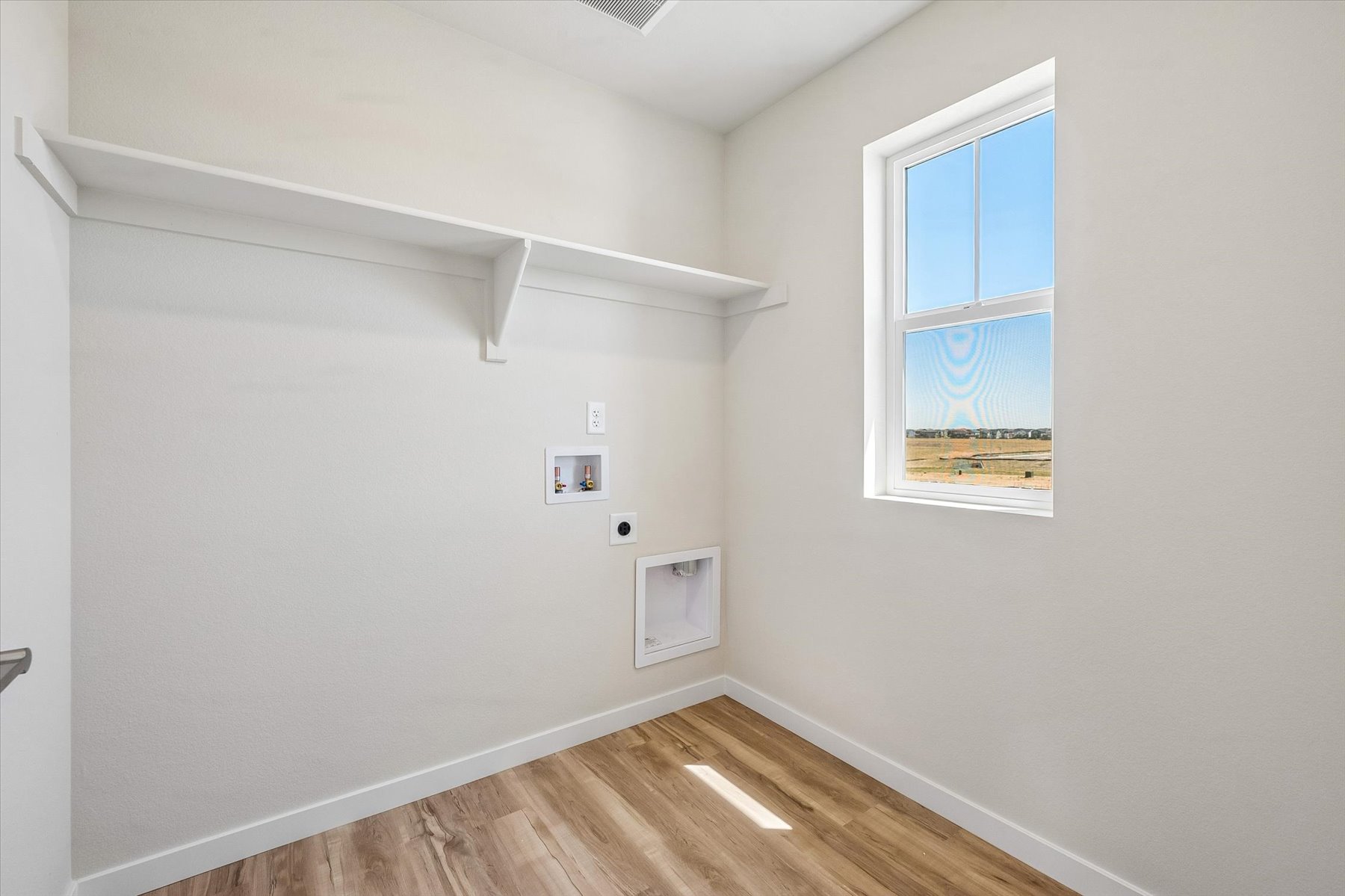 A room with a wood floor and white walls with a wood floor and a wood floor with a.