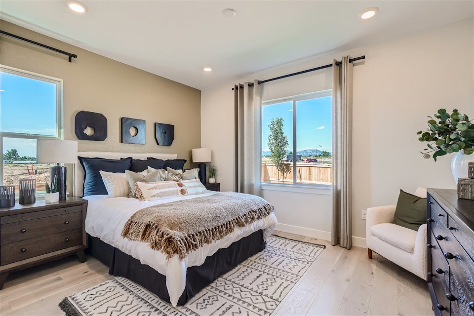 A bedroom with a large window.