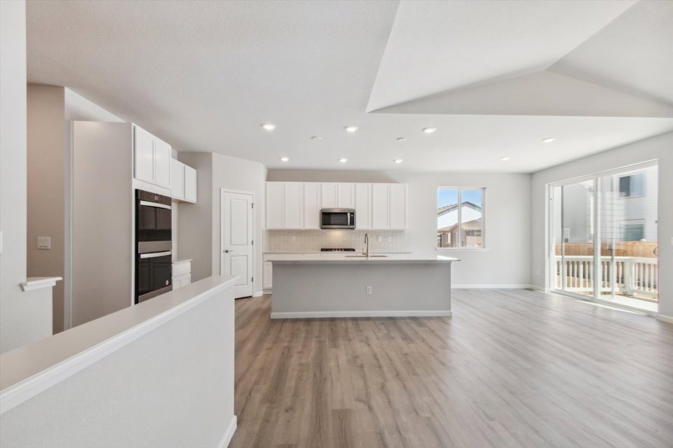 A large kitchen with white cabinets.