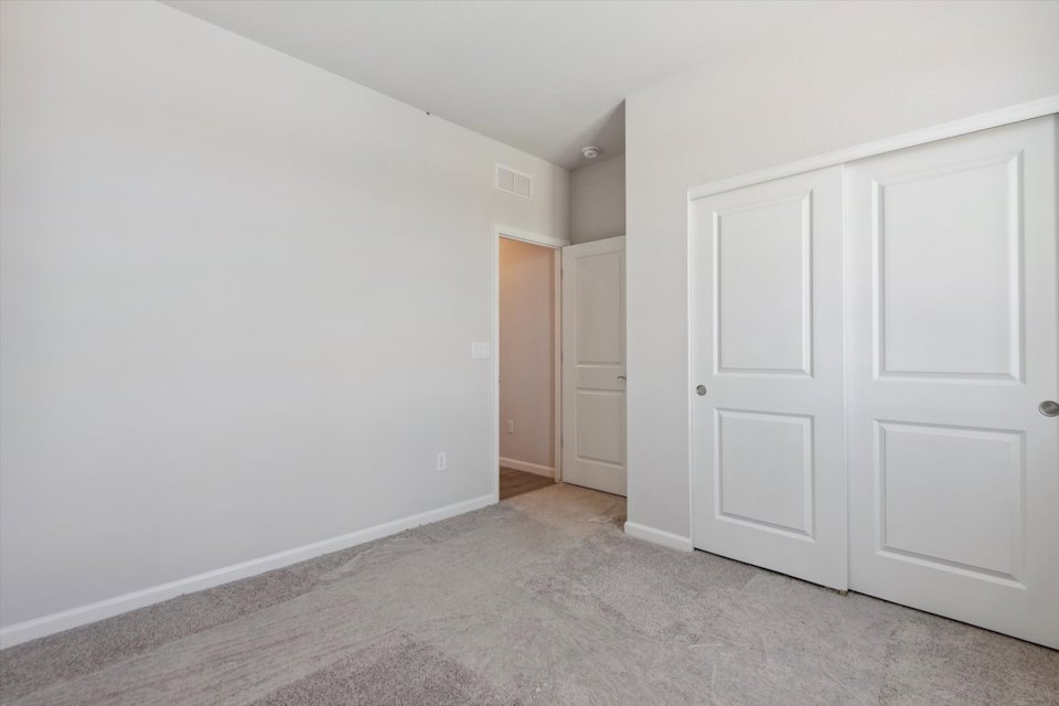 A hallway with white doors.