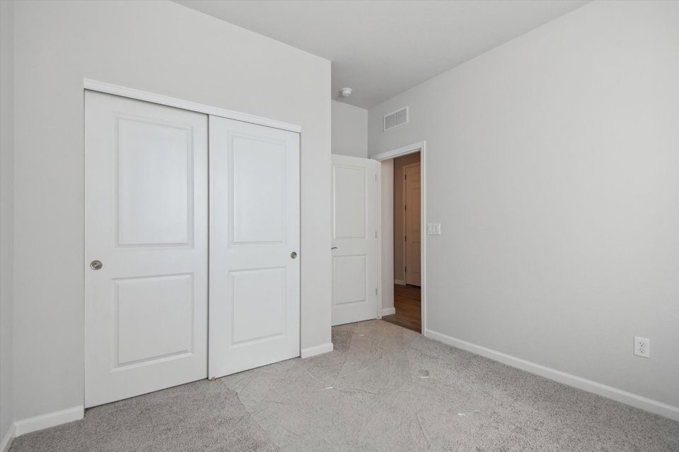 A hallway with white doors.