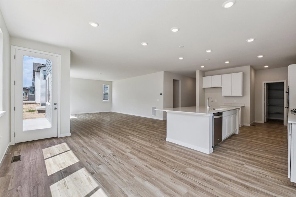 A kitchen with wooden floors.