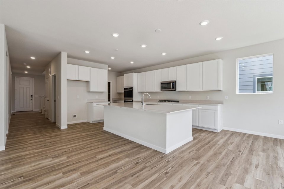 A kitchen with white cabinets.
