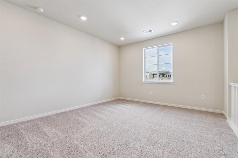 A room with a window and a carpet.