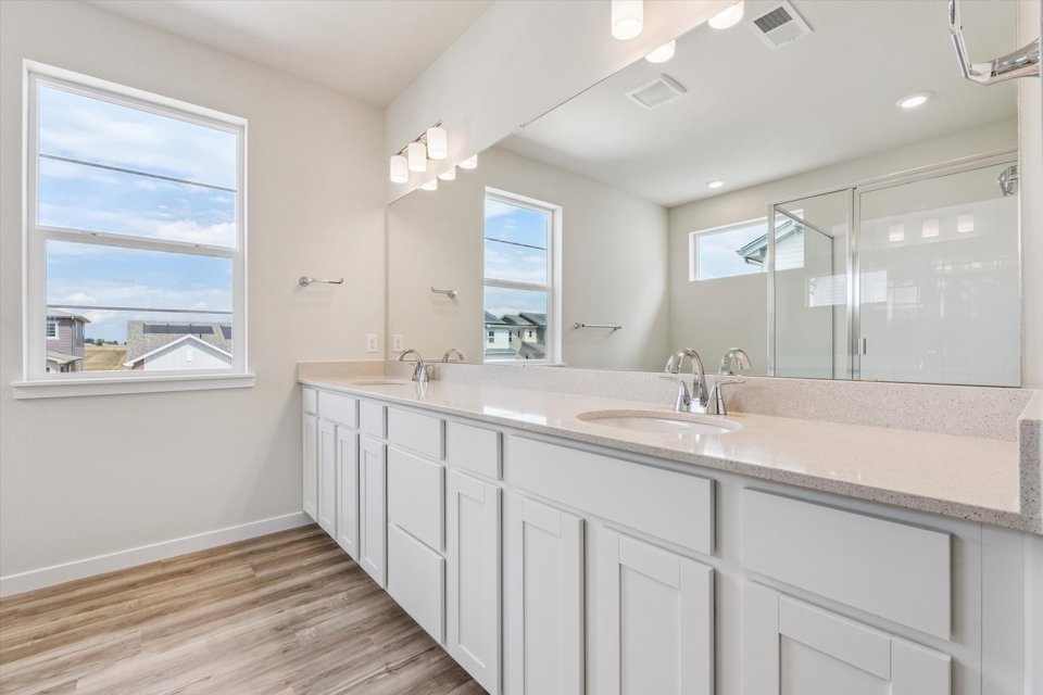 A bathroom with white cabinets.