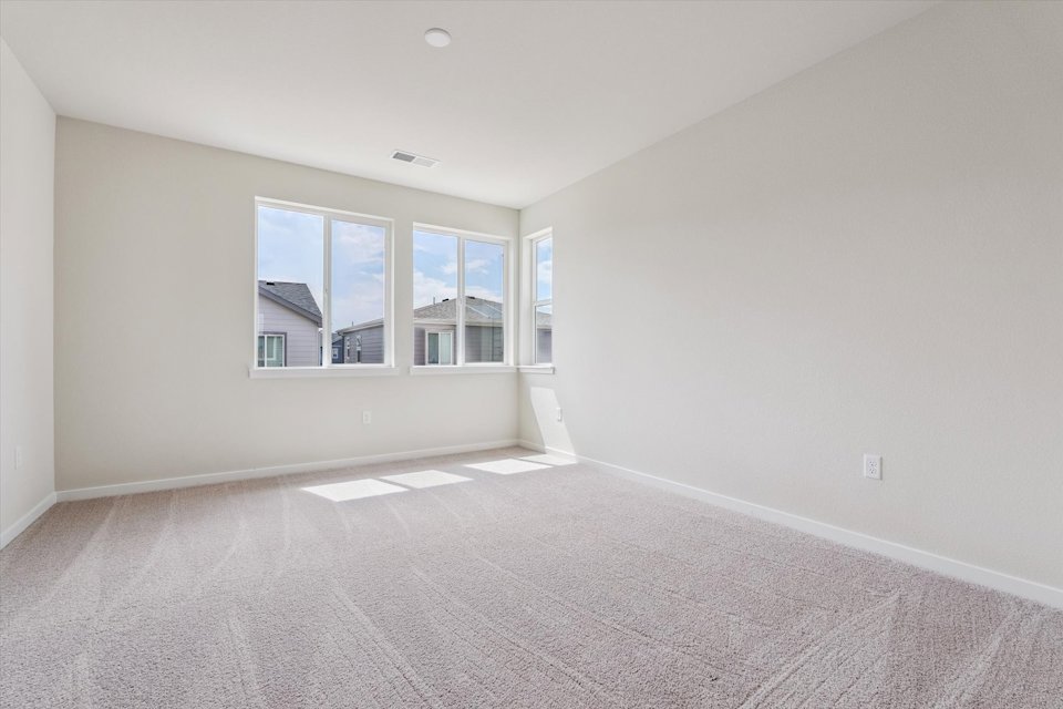 A room with a window and a carpet.