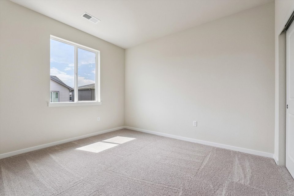 A room with a window and a carpet.